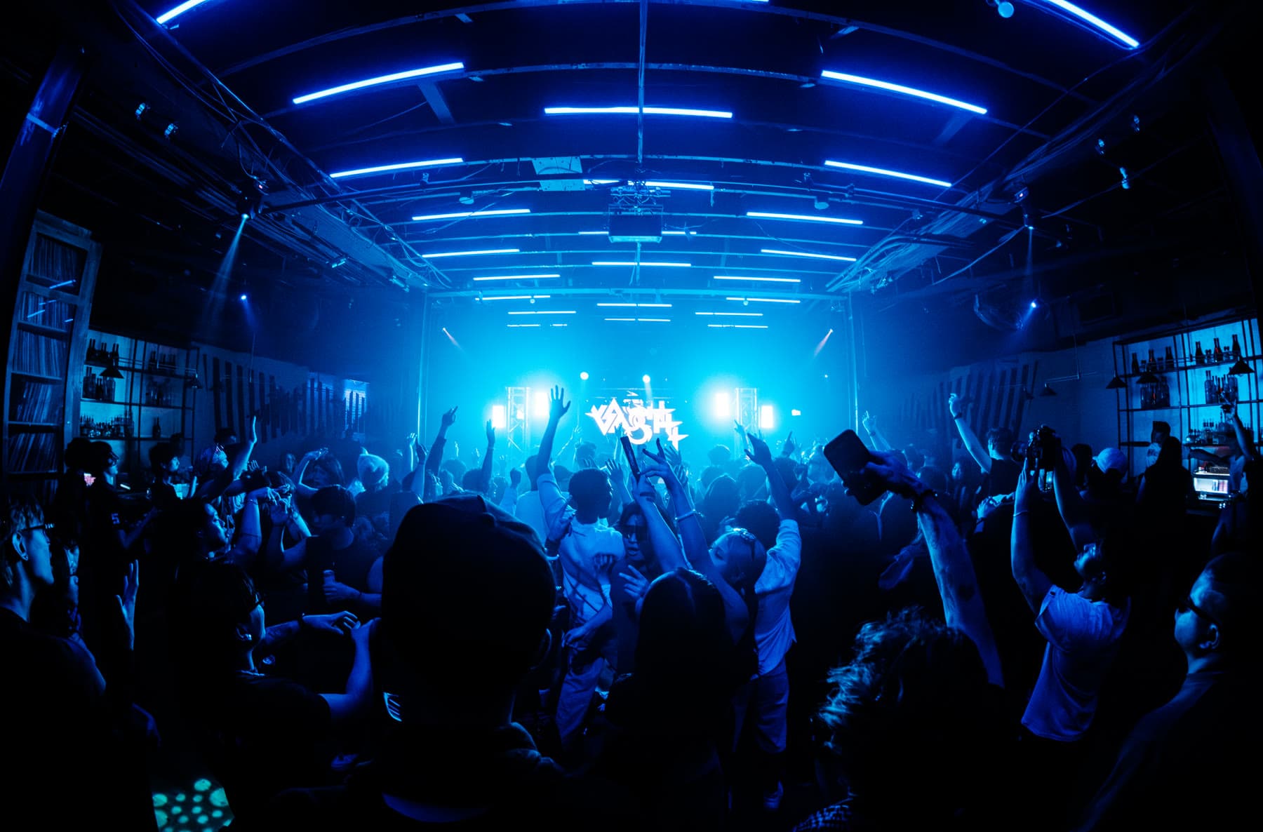 A room washed entirely in deep blue, silhouettes across the floor