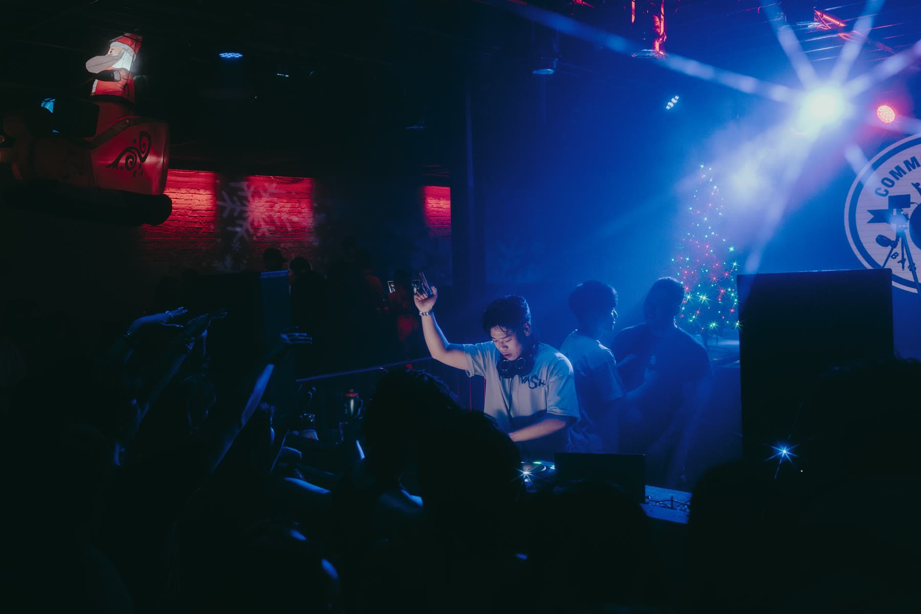 A dark room split between red and blue light, guests dancing